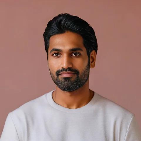 A man with a beard wearing a white shirt.